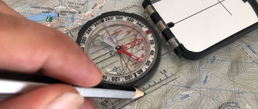 Lay your map out on a flat surface and locate the landmark you have just taken a bearing from.