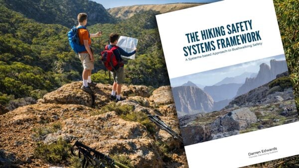 Cover image of the hiking safety systems framework showing two bushwalkers navigating with a map above a rugged australian valley landscape.